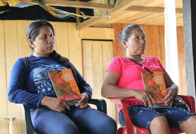 women holding protection manuals